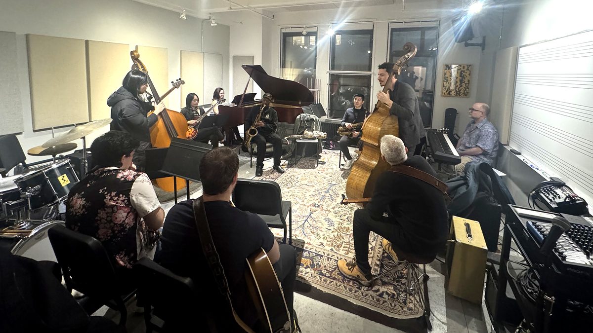 Musicians and students playing together in the room where NYMI's classes happen