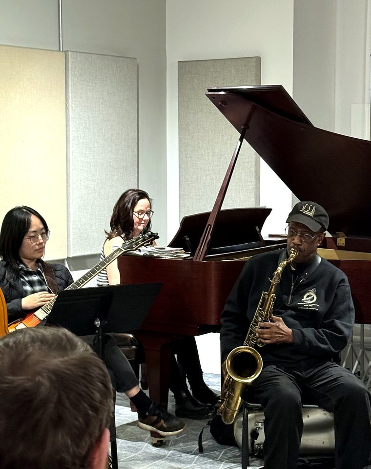 Patience Higgins on saxophone with guitar and piano at a NYMI class